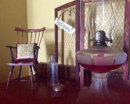 In the hallway/living room nook on a miniature rocker